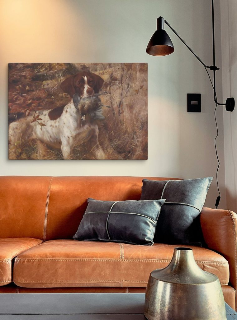 Quail hunting artwork of a german shorthair pointer with a quail displayed over a leather sofa
